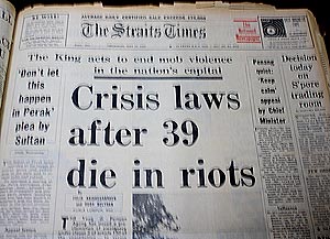 newspaper headlines ''Crisis laws after 39 die in riots' from the Strait Times'