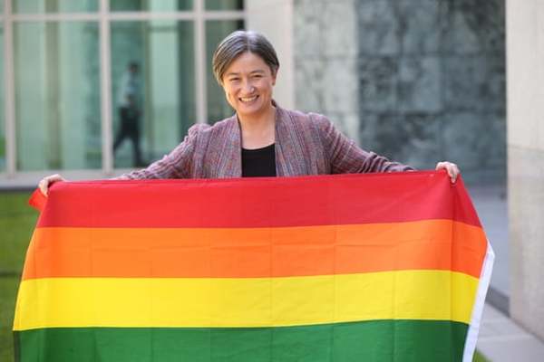 Penny Wong carries the rainbow flag in celebration in 2017.