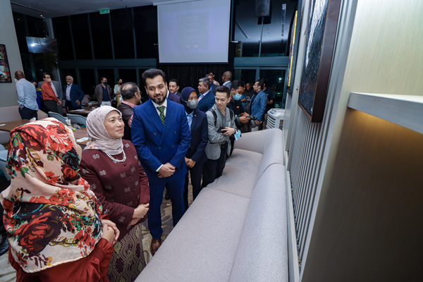 Minister of Tourism, Arts, and Culture Dato Sri Hajah Nancy Shukri (second from left) and Mart Expo founder Mohsen Golshiri (third from left) admiring one of the artworks on display at the launch of the event.