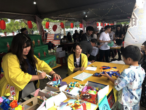 A child trying out a game booth at a Bon Odori festival in Malaysia in 2019.