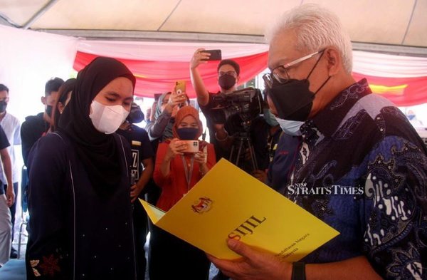 Rohana Abdullah while receiving her Malaysian citizenship approval letter from Home Minister Hamzah.