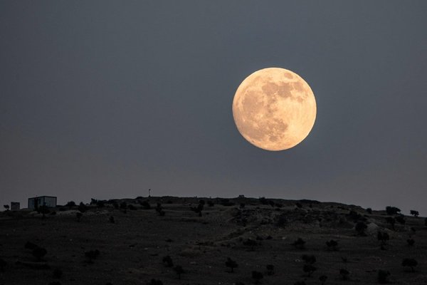 A supermoon rising in the countryside of the village in Aleppo, Syria on 13 June 2022.