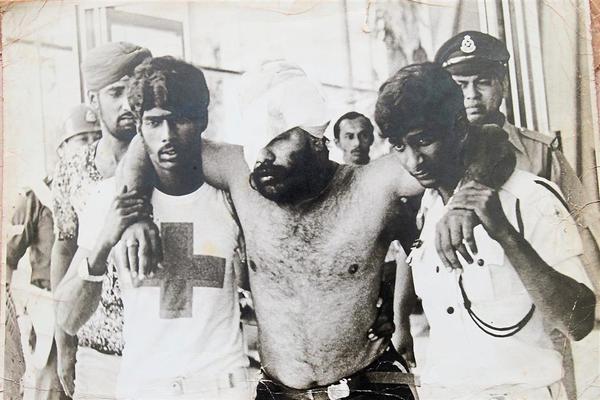 Sukhdev being led out of the building after sustaining crucial injuries to his eye.