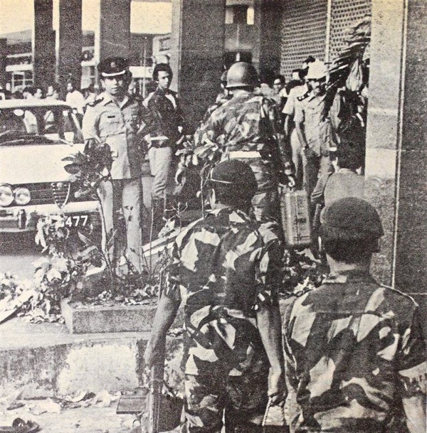 Police guards and soldiers gathered outside the building in contemplation of their next step.