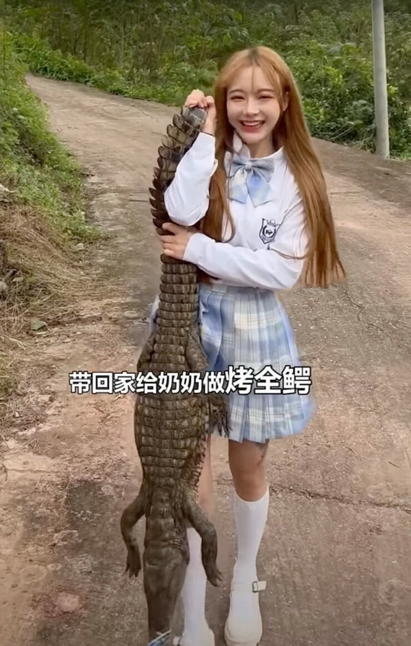 Tizi holding a crocodile.