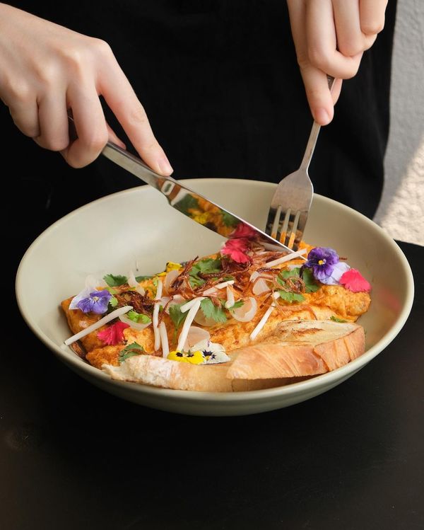 A Korean-fusion dish, kimchi omelette, served with ciabatta bread and fried shallots.