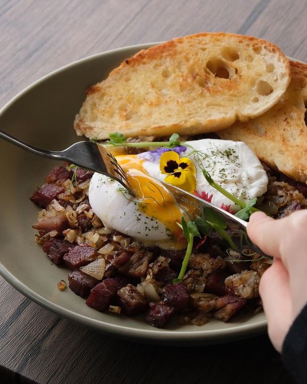 The Dons Corn Beef Hash, a housemade salt beef dish, served with toast and sunny-side eggs.