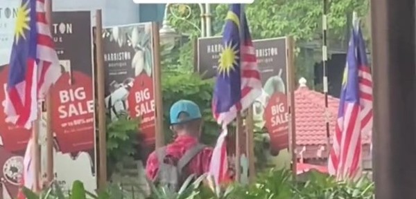 One of the many defaced Jalur Gemilang flags that the man cut up.