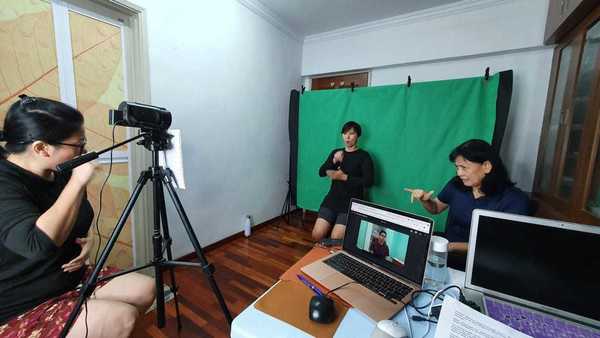 Lim working on an educational video with deaf interpreters.