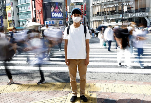 Shoji Morimoto, also known as the "Rental-Do-Nothing-Man", standing at Shibuya Crossing in Tokyo, Japan.