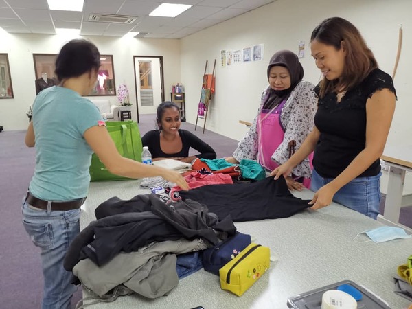 Women taking part in one of the sewing sessions organised by WOW.