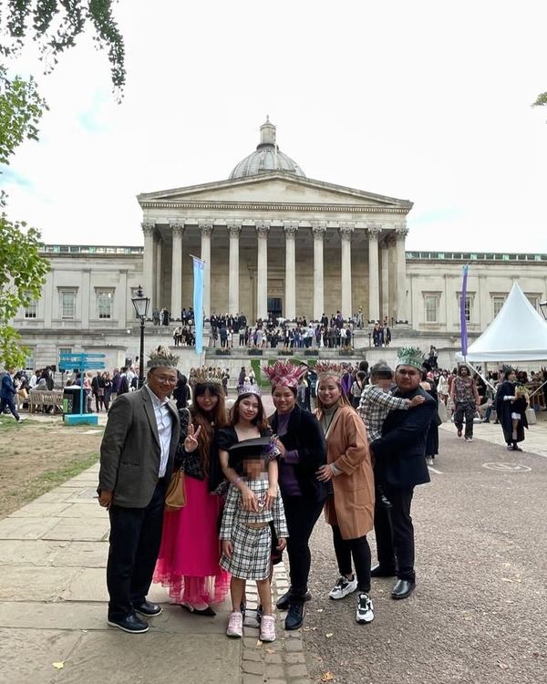 Susherrie with her family in front of the UCL campus.