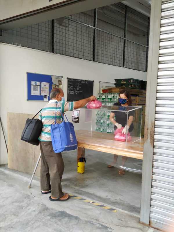 A street client picking up his food pack at Pit Stop Community Café.