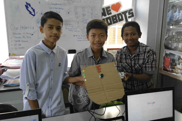 A group of students showing off their project at Arus Academy.