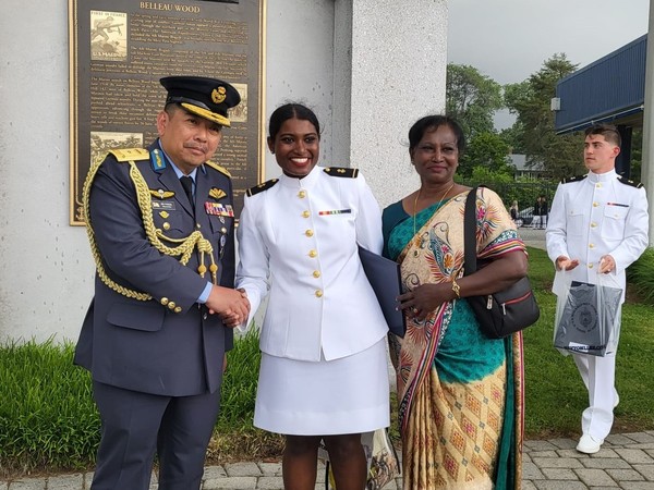 Janushaa (centre) pictured with her mother (right) at her graduation ceremony.