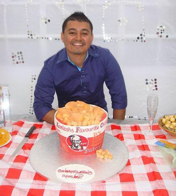 Mistry at his 25th birthday party, with a KFC-themed cake.