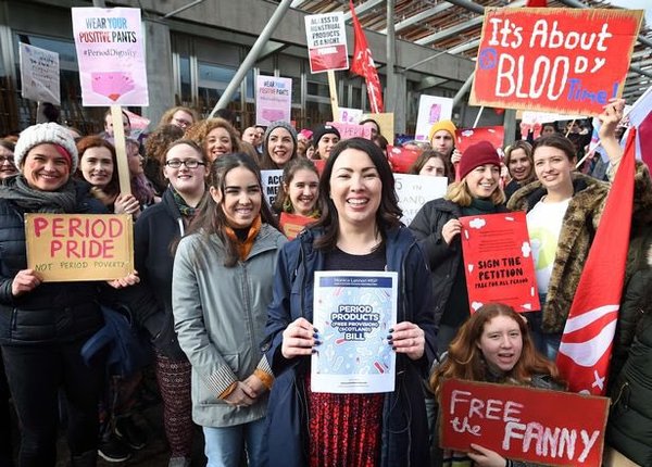 Scottish politician Monica Lennon and her supporters celebrating the new law in Scotland where citizens are provided with free period products across the country.