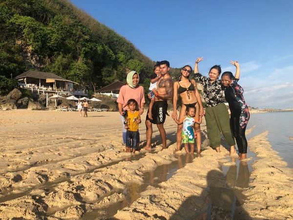 The couple with their children and Zulae's family in Bali, Indonesia.