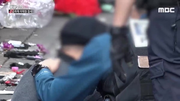 A policeman comforting the elderly store owner as he cries.