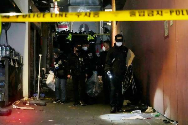 Photo of a group of police officers inspecting the scene hours after the tragedy struck.