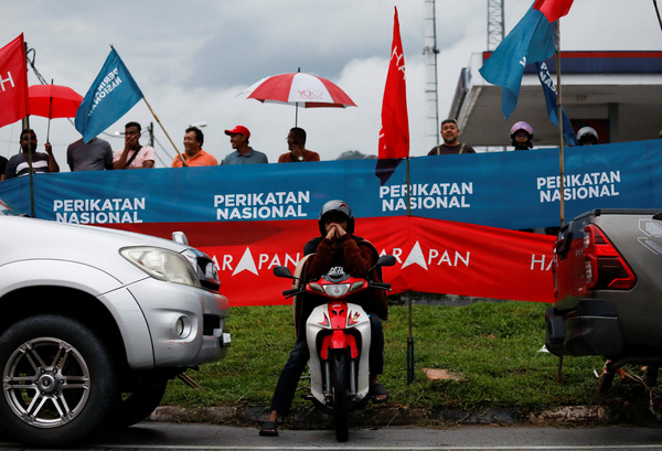 People listen to Malaysian opposition leader Anwar Ibrahim's speech during a political gathering, a day before the nomination day.