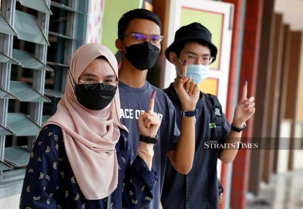 Photo shows a group of young voters.