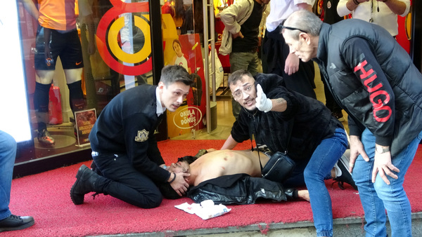 People attend to a wounded man after an explosion in Istiklal Street in central Istanbul, Turkey, on 13 November 2022.