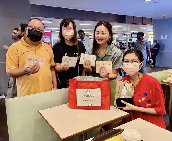 Volunteer Yuki (second from the right) collecting postal votes in Singapore.