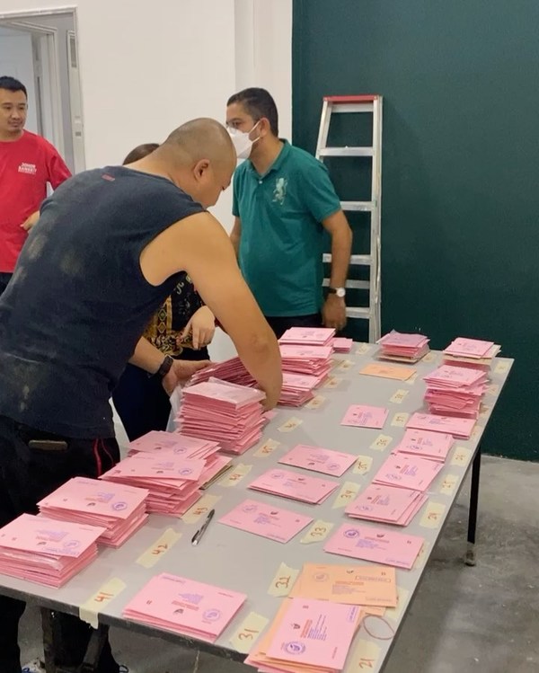 Undi18 volunteers sorting out postal votes according to their constituencies in downtown Kuala Lumpur.