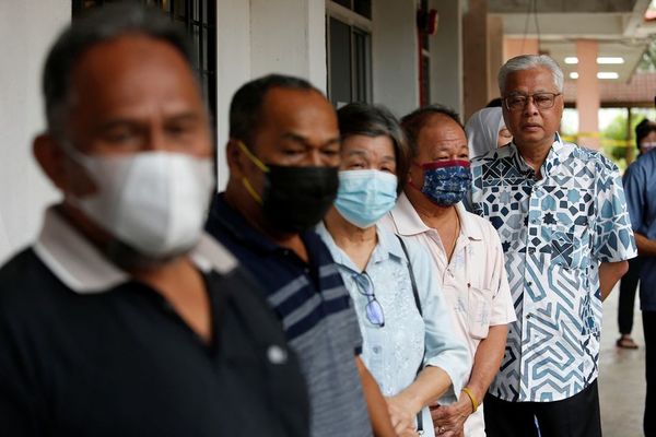 Ismail Sabri Yaakob stands in line to vote during Malaysia's 15th general election in Bera, Pahang.