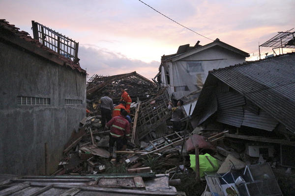 Rescuers searching for survivors among the ruins of houses in Cianjur, West Java, Indonesia.