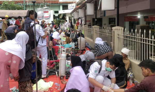 Medical workers treat the injured outside a hospital building in Cianjur, West Java, Indonesia.