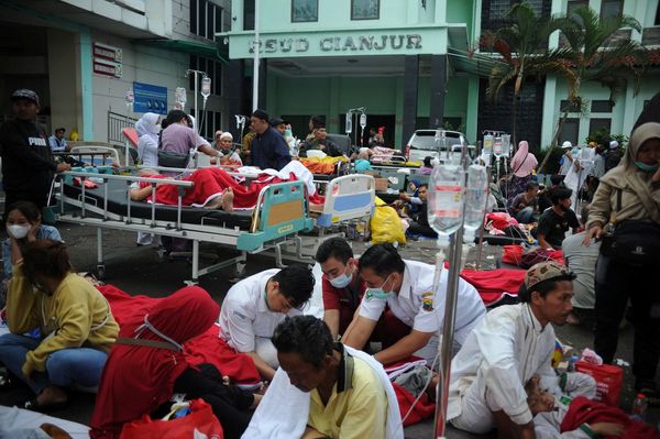 Medical workers treat the injured outside the district hospital in Cianjur, West Java, Indonesia.