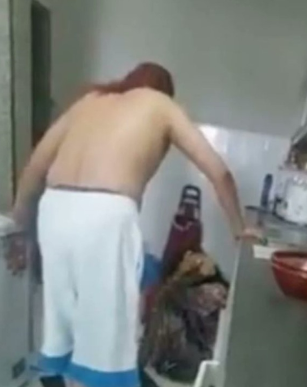 Screenshot of the video showing a man physically and verbally abusing his wife.