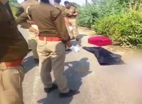 Police investigating the red suitcase containing Aayushi's body along the Yamuna Expressway, Uttar Pradesh, India.