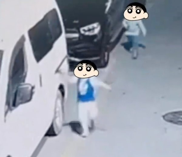 The two young boys seen dragging their toys along the neighbour's car.