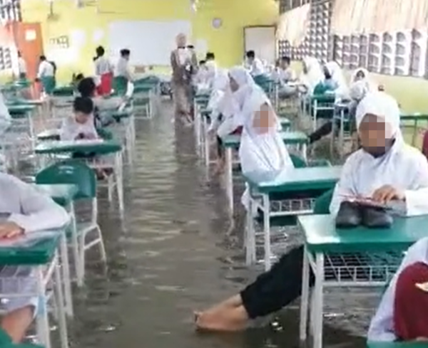 Students took their UPKK exam in a flooded classroom in Kajang yesterday.