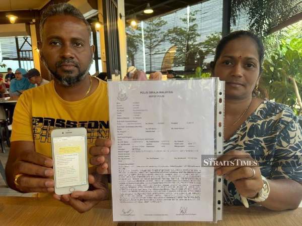 The 46-year-old victim (right) showing reporters the police report she filed against the scam operation.