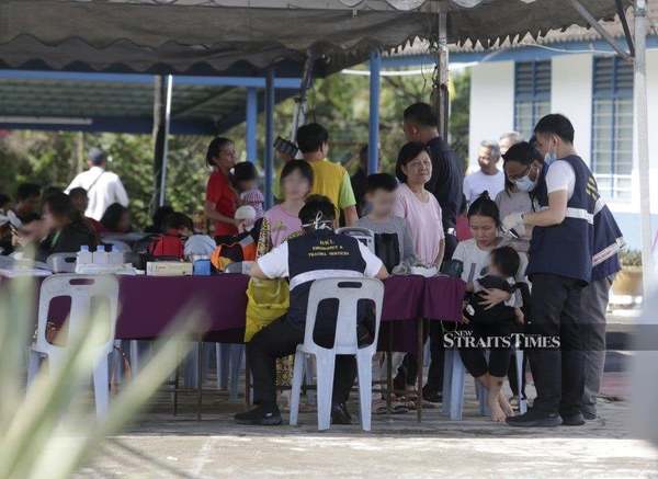 Kuala Lumpur Hospital personnel assisting the injured at the site.