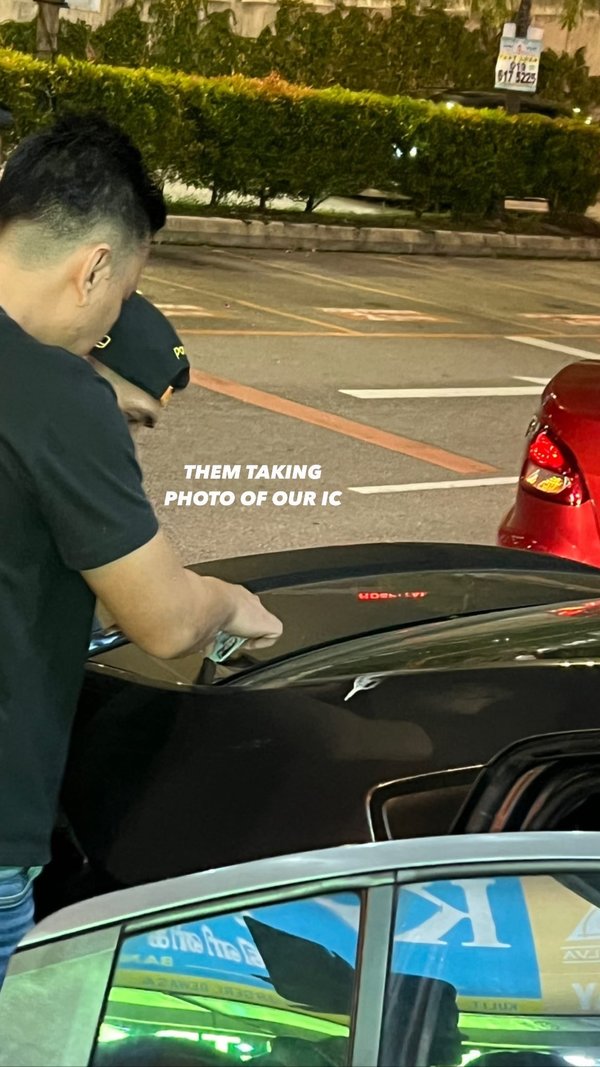 A group of three men taking pictures of Dolla members' ICs.