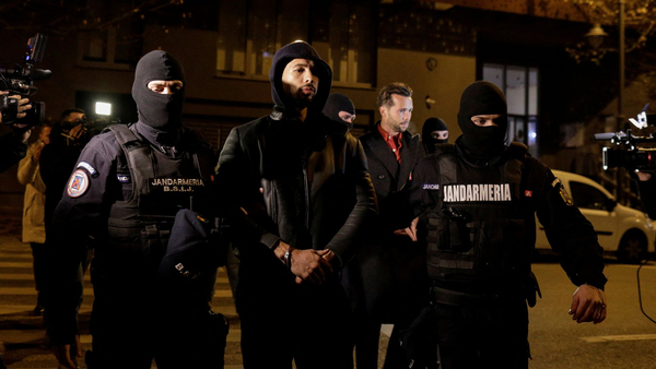 Andrew Tate (front) and his brother being detained in Romania.