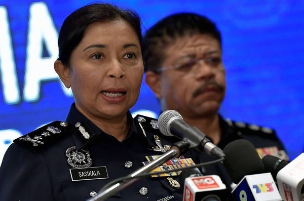 Photo of Selangor Police Chief Datuk S Sasikala Devi during a press conference, while a male officer stands beside her.