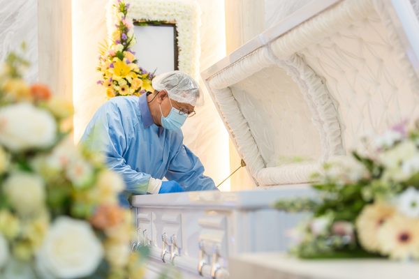 An embalmer at Casket Fairprice, working on embalming an individual.