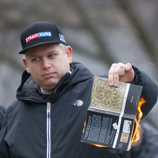 Rasmus Paludan burning the Quran outside the Turkish embassy in Stockholm on 21 January.