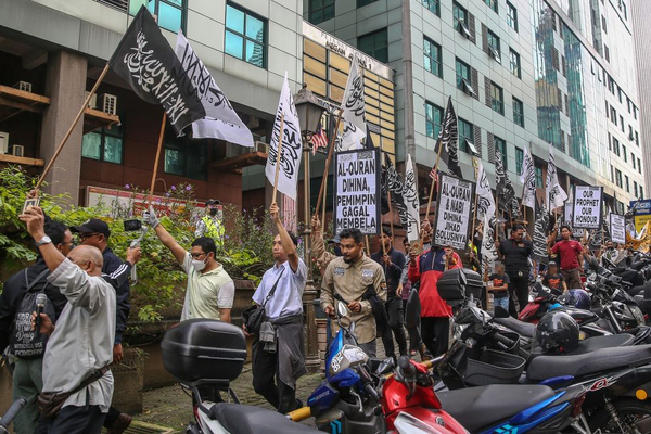 Protesters from a Malaysian hardline Muslim group, Hizbut Tahrir, hold placards as they march toward the Swedish embassy.