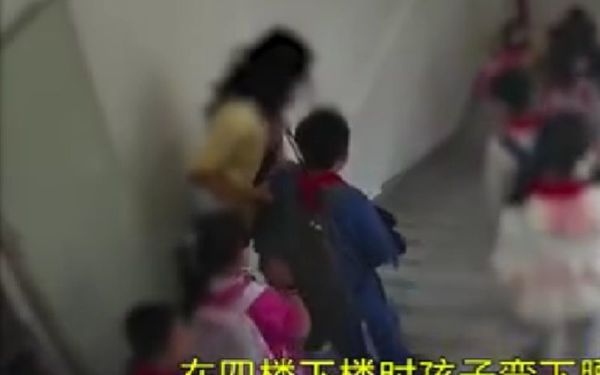 CCTV footage screenshot of the boy and the teacher walking down the stairs.