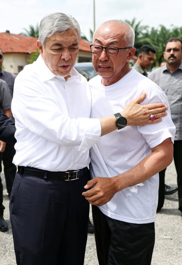 Zahid (left) consoling his close friend, Beh Song Wan.