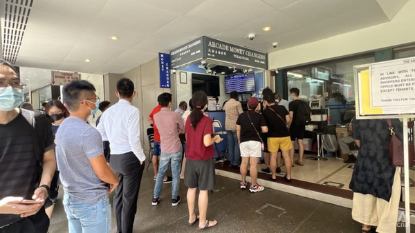 People queuing to exchange money in Singapore on 25 April 2022.