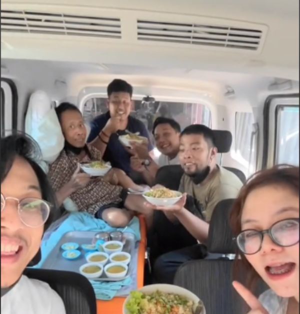 The family enjoying their meal at the back of the new van.