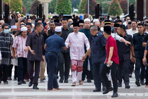 Anwar Ibrahim (centre) leaves Putra Mosque after prayers in Putrajaya.